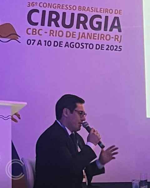 Dr. Fábio Henrique de Oliveira, coloproctologista, participando de uma mesa-redonda no 36º Congresso Brasileiro de Cirurgia, com o título do evento em destaque ao fundo.