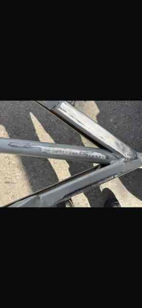 Close-up of a trailer's chassis showing irregular engraving, indicating potential tampering or alteration.
