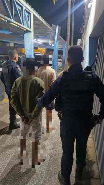 Agent arresting a suspect in a nighttime police operation.