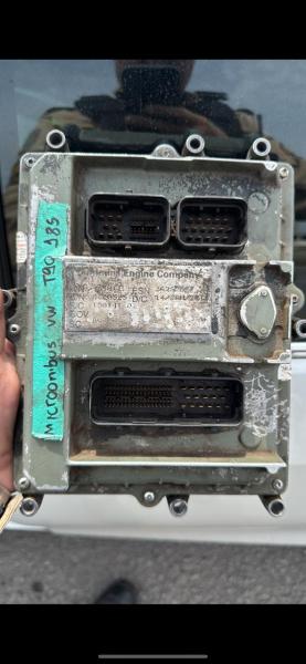 Close-up of a used automotive control unit with partially obscured identification markings.