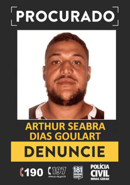 Cartaz de procurado com foto de um homem, nome: Arthur Seabra Dias Goulart, e a instrução para denunciar.