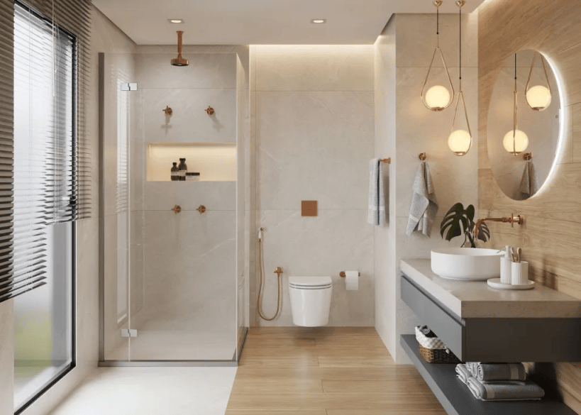 Banheiro moderno com chuveiro de vidro, vaso sanitário e pia circular. Elementos em tom madeira e detalhes em metal dourado.