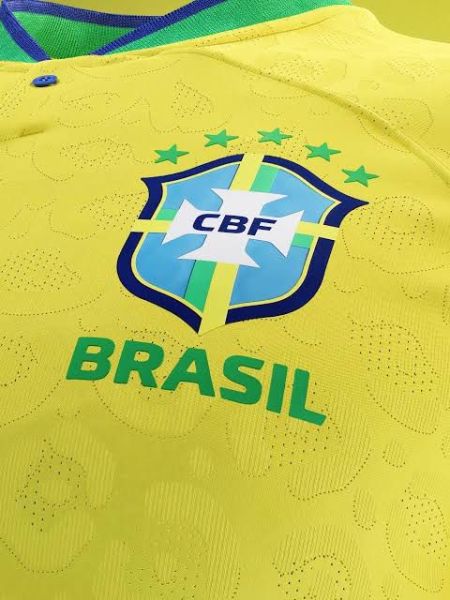 Close-up of a Brazil national soccer team jersey featuring the CBF logo and the word 'BRASIL' in green on a yellow background.