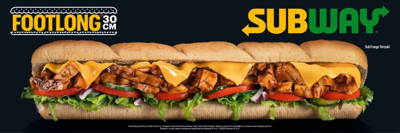 A footlong sandwich from Subway featuring grilled chicken, melted cheddar cheese, lettuce, tomatoes, and onions inside a toasted hoagie bun.