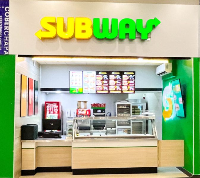 Front view of a Subway restaurant showcasing the logo, menu boards, and service counter.